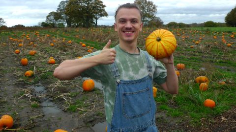 Jay holding up a gleaned pumpkin